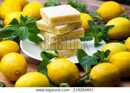 Sliced Shortcake, Many Lemons And Mint On Wooden Table