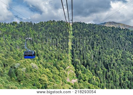 Cable way to the mountains at sunny day time.