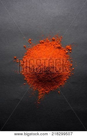 Red Chilly Powder in a bowl with dried red chillies over colourful background or pile of red chilli powder over plain background