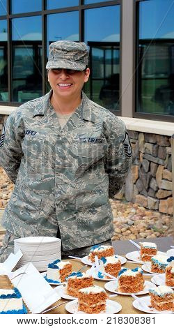 CHEYENNE, WY. JUNE 5, 2014. Air force female military soldier serving cake at a military installation reception in Cheyenne, Wy.