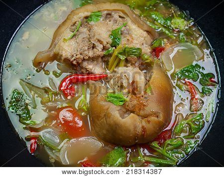 (Close Up) beef tail soup in a large boiler.
