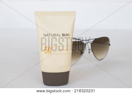 natural sun cosmetics for skin face sunscreen spf50 and accessories of woman on white