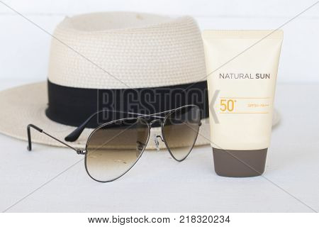 natural sun cosmetics for skin face sunscreen spf50 and accessories of woman on white