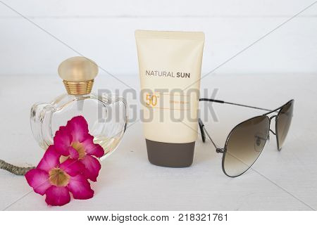natural sun cosmetics for skin face sunscreen spf50 and accessories of woman on white