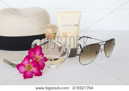 natural sun cosmetics for skin face sunscreen spf50 and accessories of woman on white