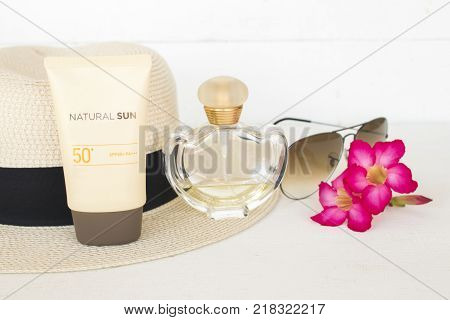 natural sun cosmetics for skin face sunscreen spf50 and accessories of woman on white