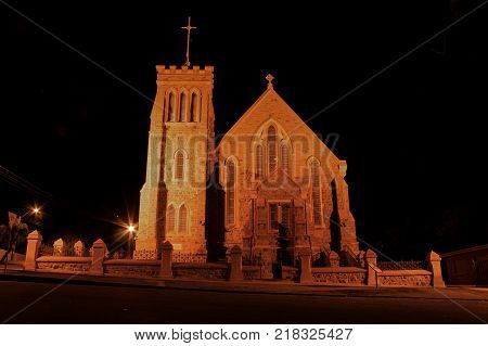 a brick church at night under lights