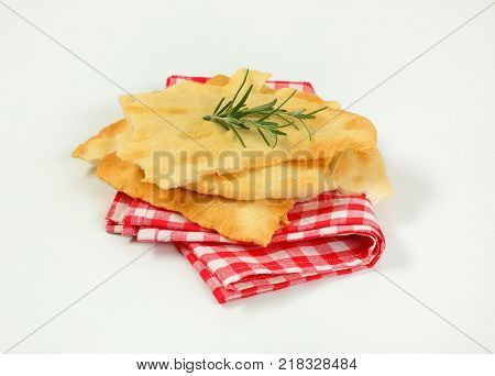 pieces of traditional Tuscan flatbread (Ghiottina Toscana) on checkered place mat