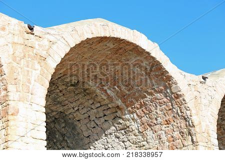 arcade made with red bricks of an ancient building