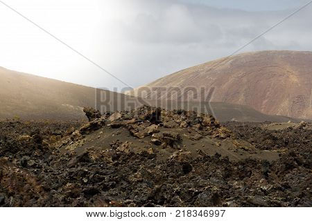 Landscape of Timanfaya National Park in Lanzarote, Canary Islands, Spain. Red and black volcanic mountains. Moon surface