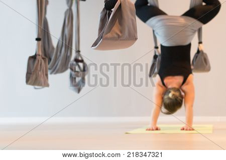 Girl is engaged in yoga on the trapeze