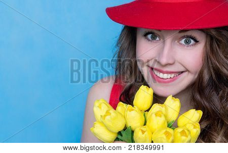 Bright Young Woman with a Bouquet of Flowers. Copy Space. Spring Concept