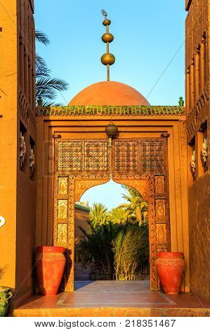 M'hamid Morocco - February 22 2016: typical arabic style front door outside view of Chez le Pacha hotel outside view with blue sky