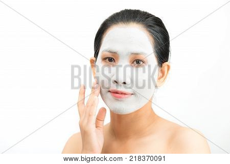 Young woman clay face mask peeling natural with purifying mask on her face on white background
