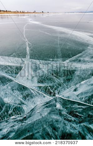 Frozen Lake Baikal. Beautiful mountain near the ice surface on a frosty day. Natural background. Russia. Siberia