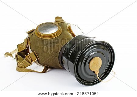Gas mask from ww2 real war. Used vintage green and black gas mask can illustrate danger, war, catastrophe, or other concept. Gas mask on isolated white studio background. Easy to use for your work. War mask.