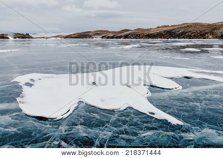 Frozen Lake Baikal. Beautiful mountain near the ice surface on a frosty day. Natural background. Russia. Siberia