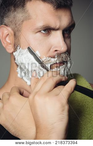 happy hipster in barbershop new technology. Haircut of bearded man archaism. Fashion and beauty innovation. Barber and hairdresser. Man cut beard and mustache with razor and shaving brush.