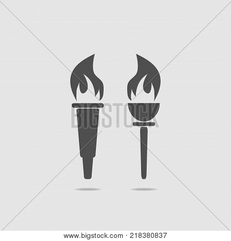 Set of two torches with fire. On a light background, in gray. Icon torch. Vector illustration.