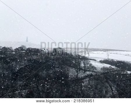 stoodley pike and surrounding moors in heavy snow in west yorkshire