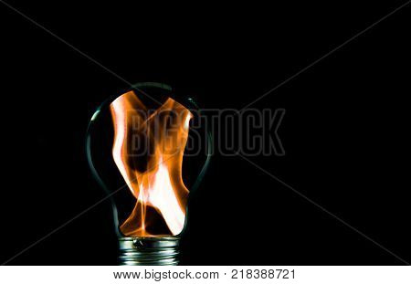 Flames in the light bulb isolated on black