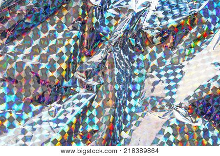 Hologram paper, holographic . Holographic holologram paper background texture. Silver with rainbow reflection.
