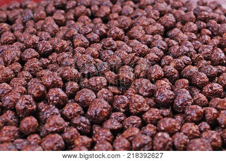 Chocolate cereals. Cereal background. Choco breakfast cereal balls as texture pattern closeup background. Food cereals photo.