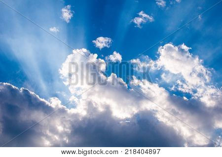 heavenly sunrays through clouds, cloudy sky background
