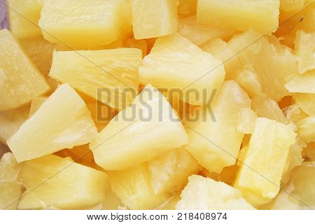 Pineapple slices as background. Yellow pineapples texture pattern. Pineapple fruit.