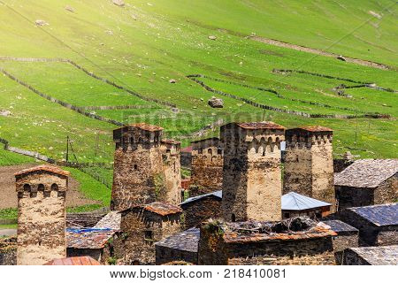 View of the Ushguli village at the foot of Mt. Shkhara. Picturesque and gorgeous scene. Rock tower in Ushguli - the highest inhabited village in Europe