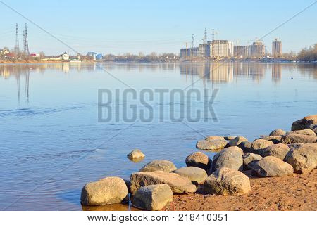 View of Neva river and microdistrict Ribatskoe on the outskirts of St. Petersburg at sunny spring day Russia.