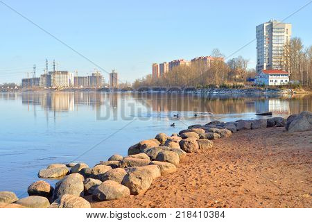 View of Neva river and microdistrict Ribatskoe on the outskirts of St. Petersburg at sunny spring day Russia.