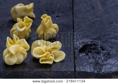 Fagottini pasta on dark rustic wood picture
