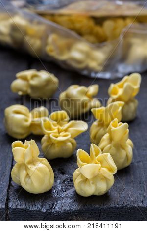 Fagottini pasta on dark rustic wood picture
