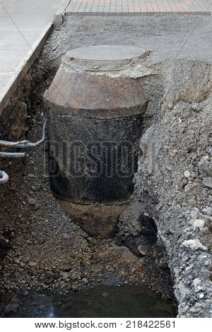 Repair of street municipal sewerage - a sewerage well is excavated around it water.