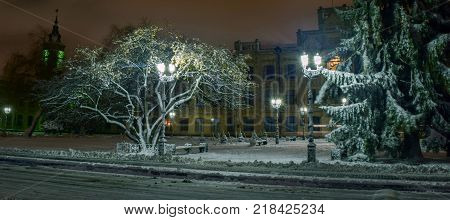 Snowy evening landscape of the city square.