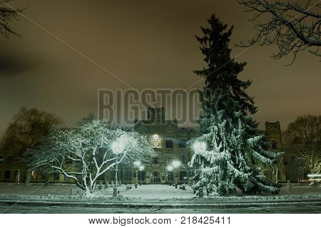 Snowy evening landscape of the city square.