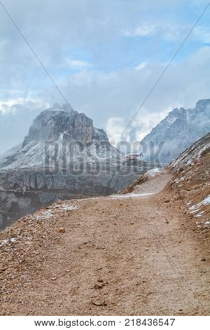 Tre Cime di Lavaredo in beautiful surroundings in the Dolomites at foggy weather in Italy Europe (Drei Zinnen)