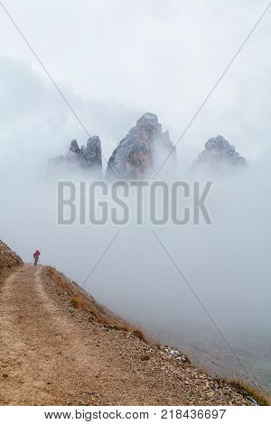Tre Cime di Lavaredo in beautiful surroundings in the Dolomites at foggy weather in Italy Europe (Drei Zinnen)