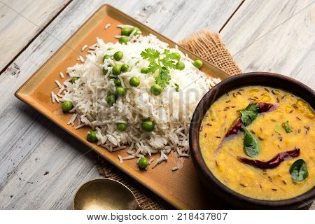 Basmati Rice Pilaf or pulav with Peas, or vegetable rice using green peas also known as matar pulav, served with plain dal