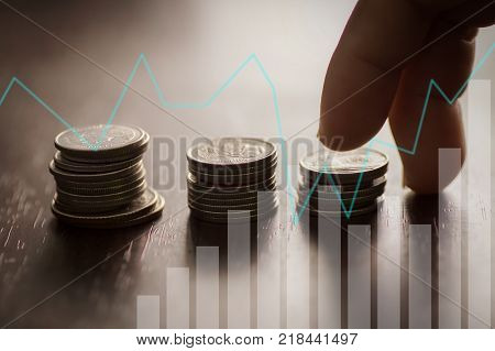 Finance capital banking and accounting growing up concept finger step on money coins staced graph