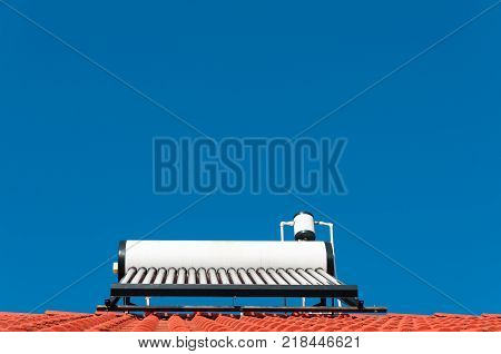 Solar water heater with perfect blue sky.