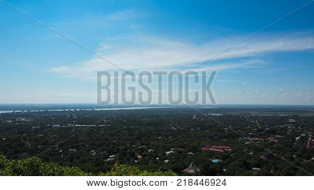 High angle view of multiple temples and pagodas on the mountains with Irrawaddy river in the background from sagaing hill, Sagaing region of Myanmar.