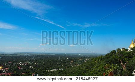 High angle view of multiple temples and pagodas on the mountains with Irrawaddy river in the background from sagaing hill, Sagaing region of Myanmar.