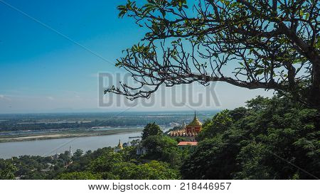 High angle view of multiple temples and pagodas on the mountains with Irrawaddy river in the background from sagaing hill, Sagaing region of Myanmar.