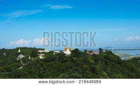 High angle view of multiple temples and pagodas on the mountains with Irrawaddy river in the background from sagaing hill, Sagaing region of Myanmar.