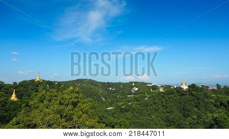High angle view of multiple temples and pagodas on the mountains with Irrawaddy river in the background from sagaing hill, Sagaing region of Myanmar.