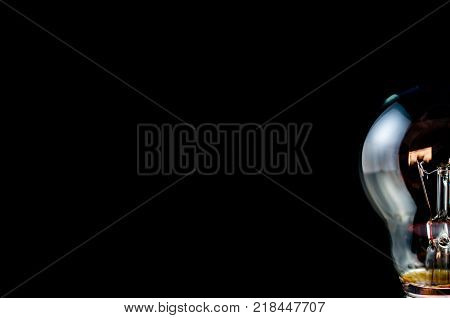 Half of light bulb isolated on black background.