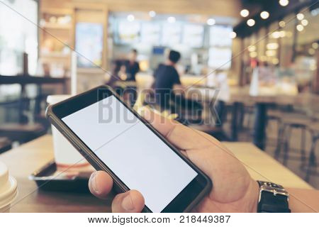 Man Hand Holding Smartphone in Restaurant Business Technology and Ordering Foon Online Concept