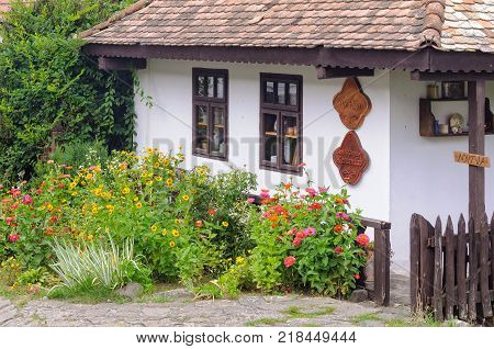 Flowers in front of a traditional Paloc farmhouse in the UNESCO World Heritage village - Holloko, Hungary, 13 July 2013
